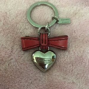 Coach keyring Silver heart with a red bow.